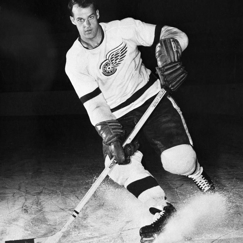 Gordie Howe for Detroit Red Wings posed with puck