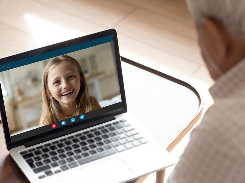 Grandfather have video call with granddaughter