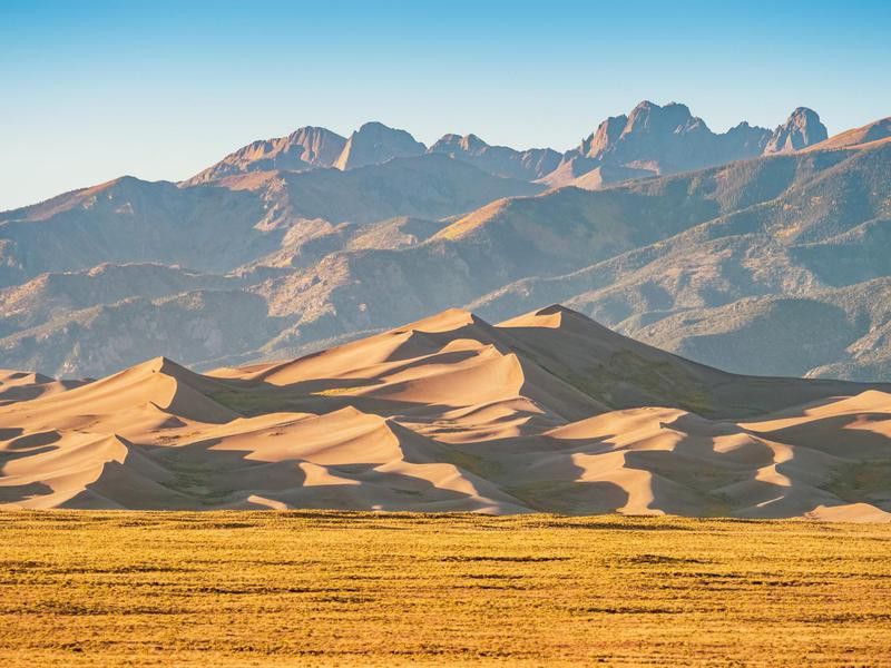 Great sand dunes with mountains in the backdrop