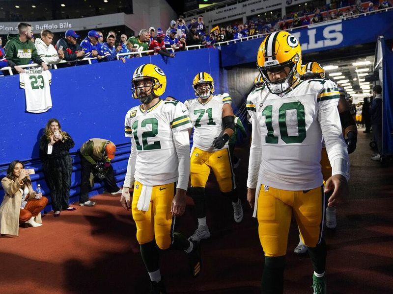 Green Bay Packers quarterbacks Aaron Rodgers (12) and Jordan Love (10)