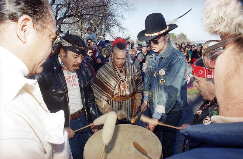 Group of Native Americans beat a drum