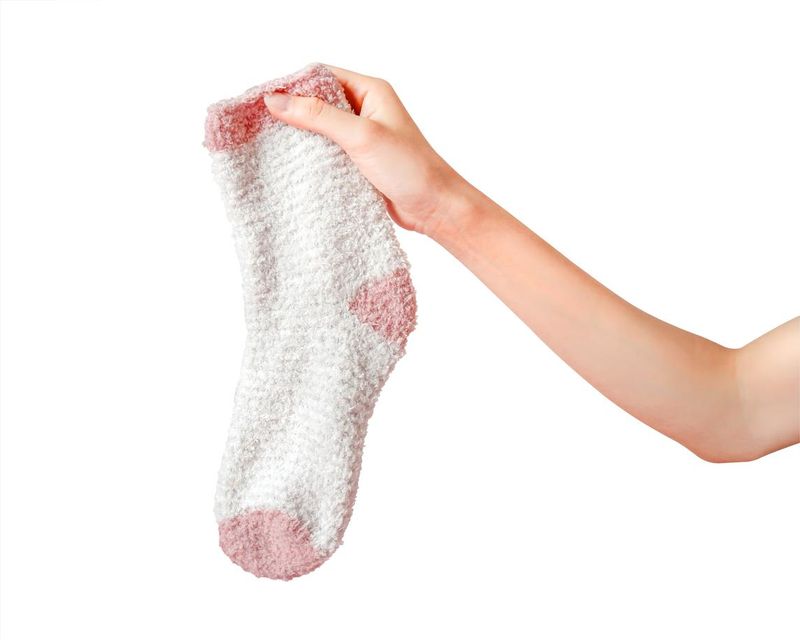Hand holding a pink sock