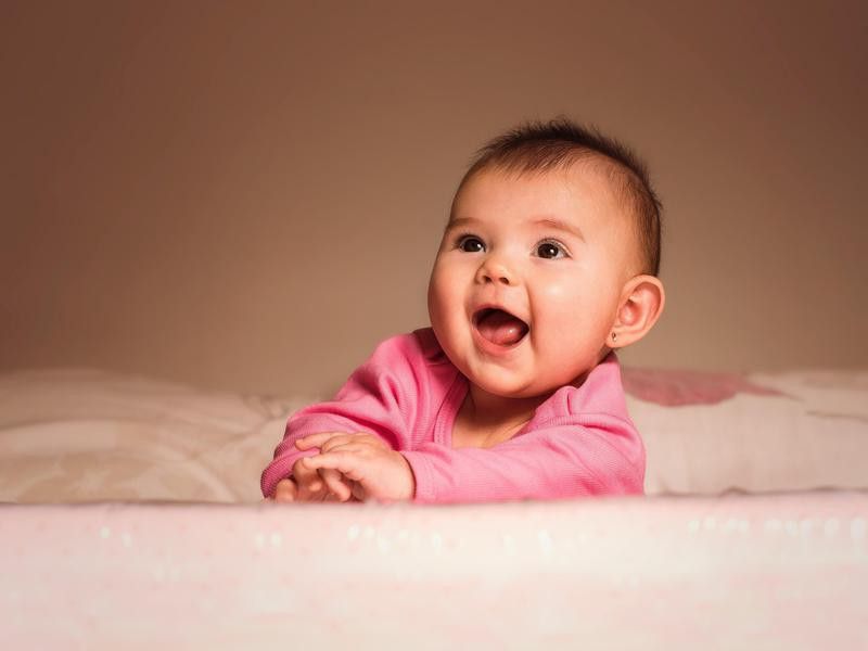 Happy bilingual baby smiling
