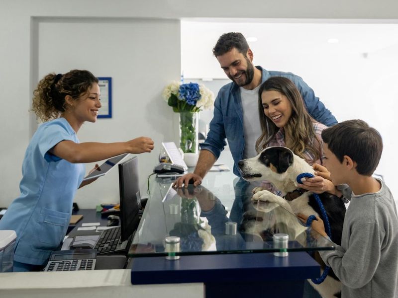 Happy family taking their dog to the vet
