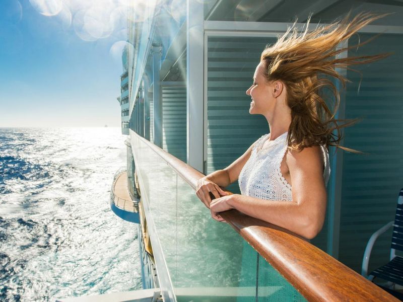 Happy woman looking at sea from a cruise ship