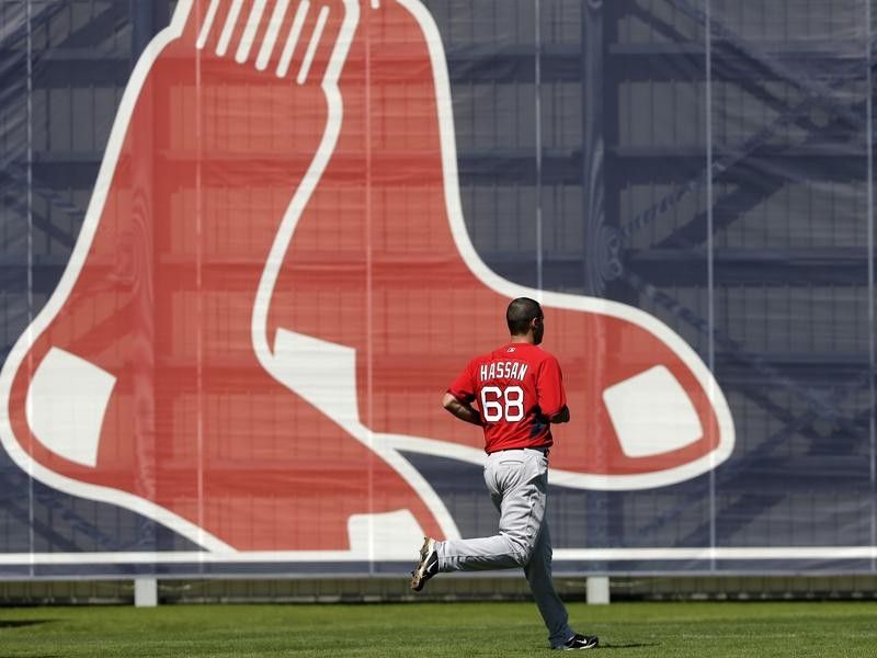 Hassan Runs by Large Red Sox Logo