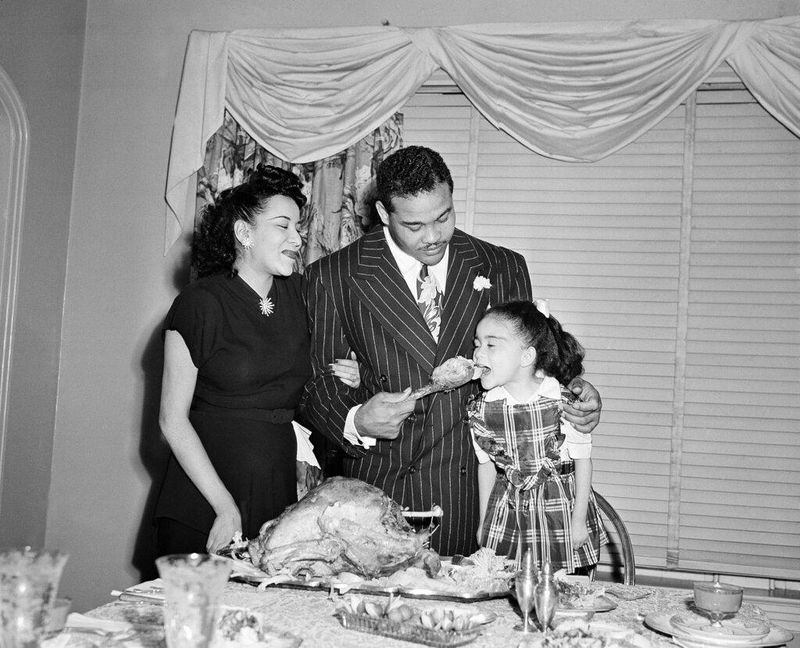 Heavyweight boxing champ Joe Louis with family on Thanksgiving