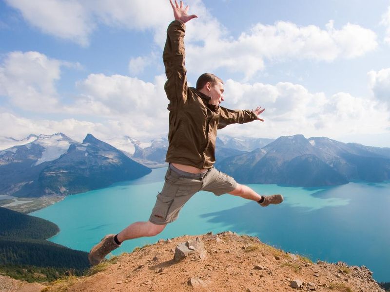 Hiker jumping for joy at a panorama ridge