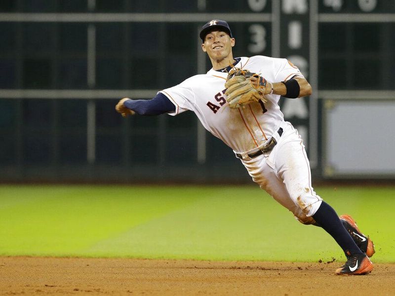 Houston Astros shortstop Carlos Correa fields a ball