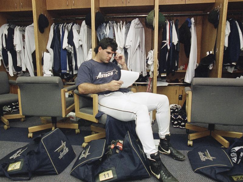 Houston Astros third baseman Ken Caminiti looks over some papers
