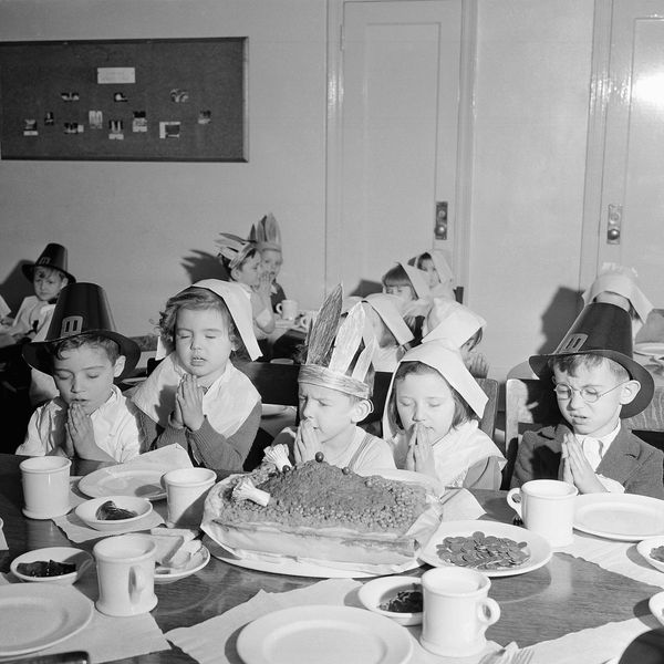 Sixty small children from New Yorks tenements ate a turkey-less Thanksgiving dinner (of beef loaf) Nov. 20, 1940 and dropped 120 pennies in a plate in front of an empty place representing war-afflicted British children overseas. The pennies will be sent to purchase food for British youngsters. Saying grace before the turkey-shaped loaf are (left to right) Theadore Timms, Margaret Mackin, 4; John Hanley, 5; Joan Barthelmess, 5, and Edward Sloconi, 5. (AP Photo)