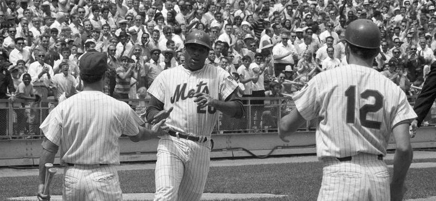 Chicago White Sox's Ken Griffey Jr. is congratulated on his first RBI  single with the team by third base coach Jeff Cox at the end of the second  inning against the Kansas