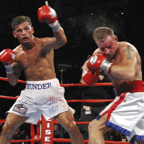 FILE - Arturo Gatti, left, punches Mickey Ward during the junior welterweight fight in Atlantic City, N.J., on Saturday, June 7, 2003. The fight lasted the the full 10 rounds and Gatti defeated Ward by a unanimous decision This was the third fight between the fighters and both fighters ended up in hospital trauma units. (AP Photo/Donna Connor, File)