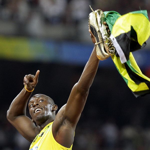 Olympic 100m champion Usain Bolt of Jamaica runs his victory lap during the athletics competitions in the National Stadium  at the Beijing 2008 Olympics in Beijing, Saturday, Aug. 16, 2008. (AP Photo/David Guttenfelder)