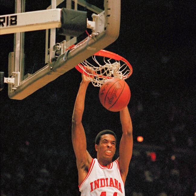 Indiana University forward Alan Henderson dunks the basketball as Ohio University forward Gary Trent looks on