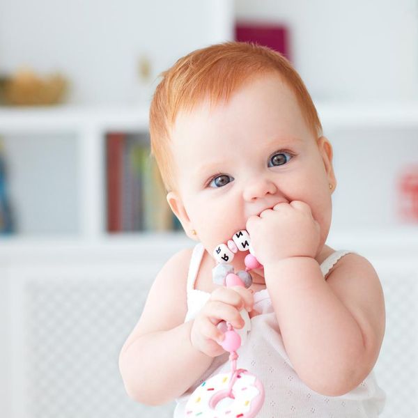 infant baby girl biting silicone nibbler toy
