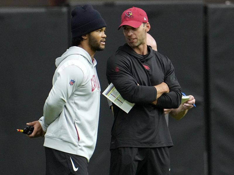 Injured Arizona Cardinals quarterback Kyler Murray, left, talks with coach Jonathan Gannon