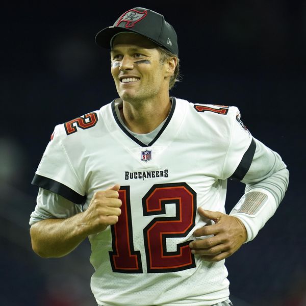 Tampa Bay Buccaneers quarterback Tom Brady (12) smiles as he runs off the field after an NFL preseason football game against the Houston Texans, Saturday, Aug. 28, 2021, in Houston. (AP Photo/Matt Patterson)