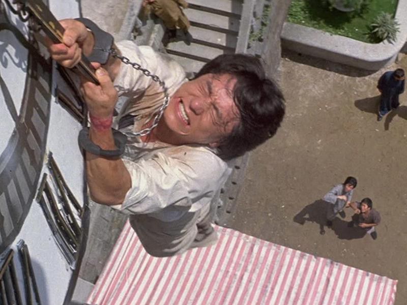 Jackie Chan Hanging From a Clock Face and Letting Go