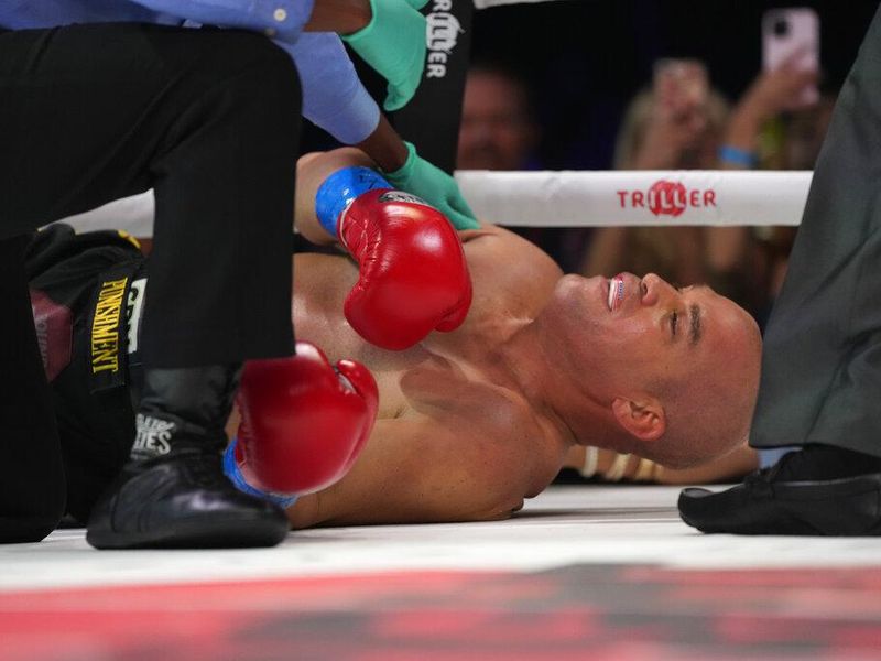 Jacob "Tito" Ortiz lies on the mat after being knocked out by fellow MMA fighter Anderson Silva during the first round of their boxing match