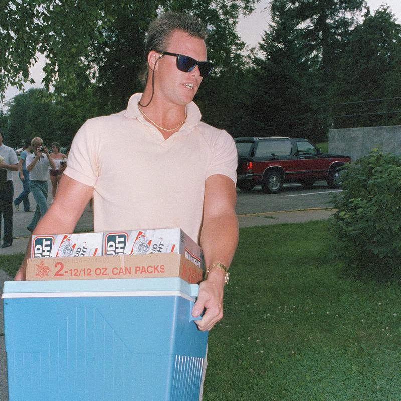 Jim McMahon of the Chicago Bears carries cooler