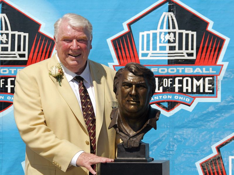 John Madden poses with his bust