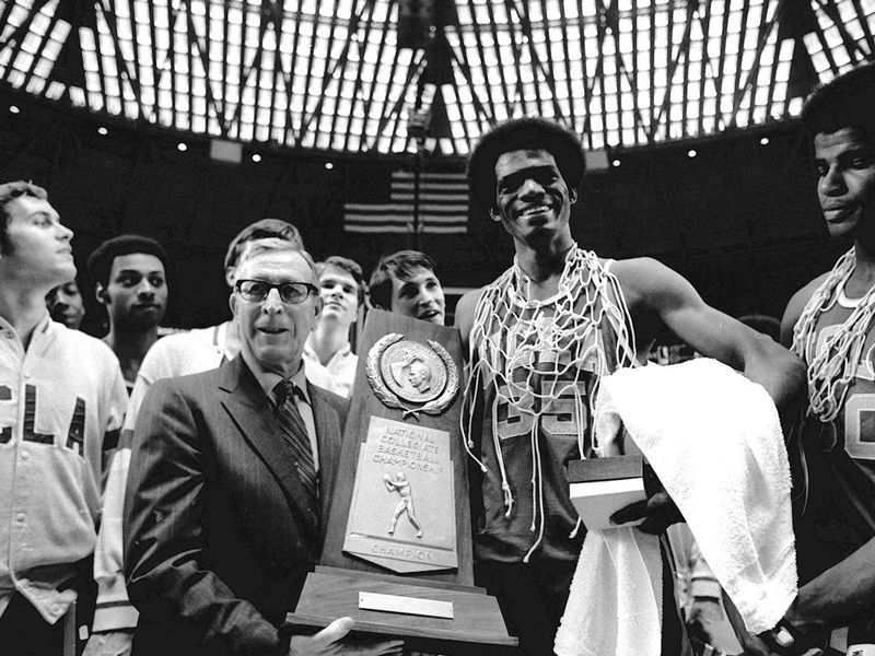 John Wooden holds championship trophy with Bruins