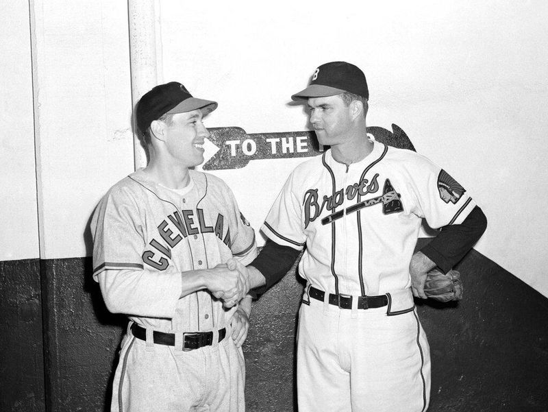 Johnny Sain, right, of the Boston Braves, shakes hands with Clevelands Bob Feller