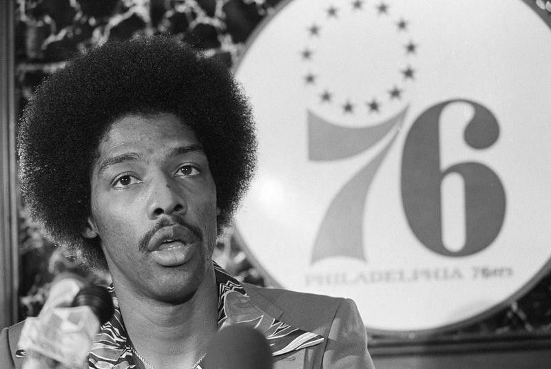 Julius Erving answers questions during a news conference
