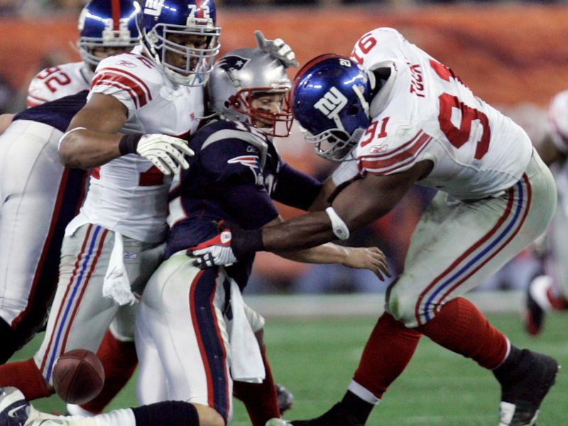 Justin Tuck forces New England Patriots quarterback Tom Brady to fumble