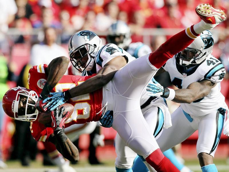 Kansas City Chiefs wide receiver Dwayne Bowe is tackled by Carolina Panthers defensive back Josh Thomas