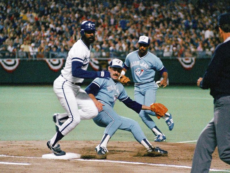 Kansas City Royals batter Willie Wilson, left, hits first base with Toronto Blue Jays pitcher Dave Stieb