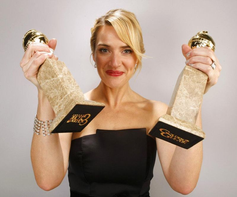 Kate Winslet holding awards