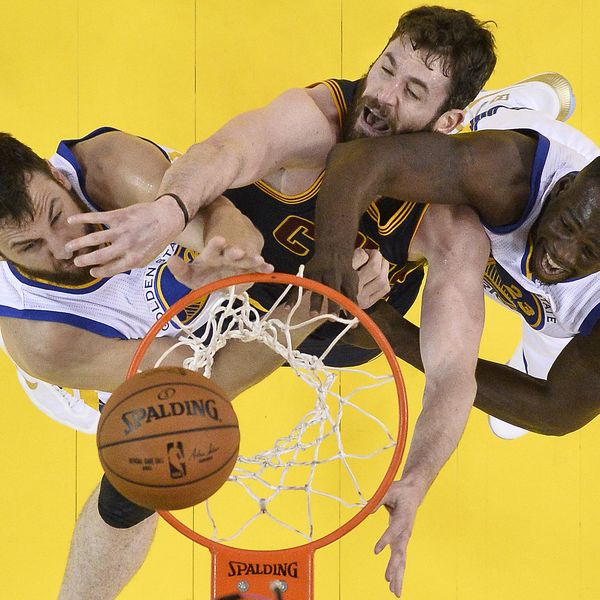 Cleveland Cavaliers forward Kevin Love, center, reaches for the ball between Golden State Warriors center Andrew Bogut, left, and forward Draymond Green during the first half of Game 2 of basketball's NBA Finals in Oakland, Calif., Thursday, June 2, 2016. (John G, Mabanglo, European Pressphoto Agency via AP, Pool)