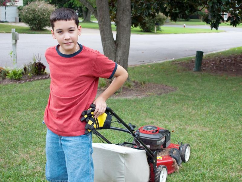 Kid mowing the lawn