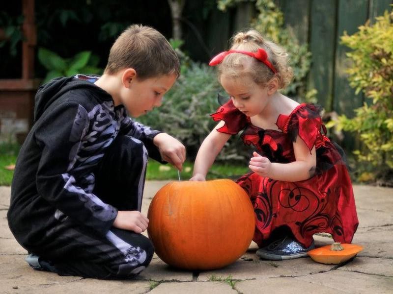 Kids carving a pumpkin