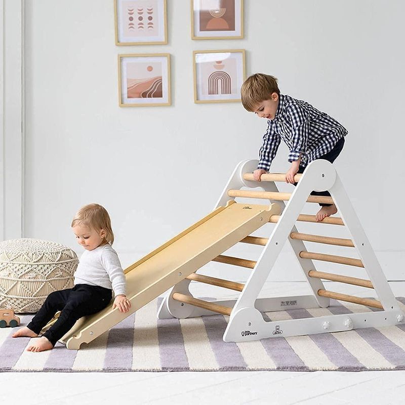 Kids climbing on a Pikler triangle