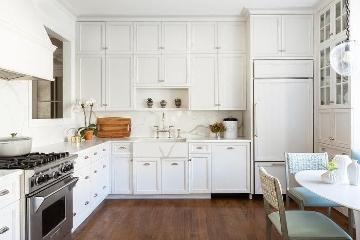 Kitchen with white cabinets and quartz farmhouse sink