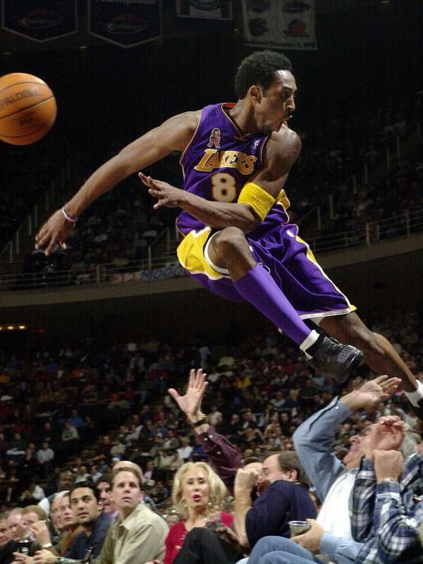 Kobe Bryant jumps over a row of fans