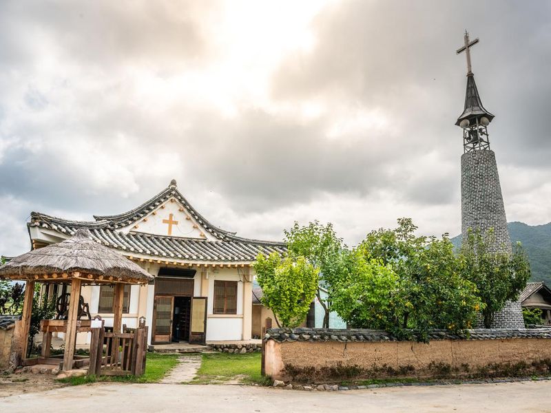 Korean style church and cross in historic Hahoe folk village with dramatic light in Andong South Korea