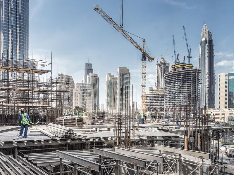 Laborers working on urban development construction site in Dubai