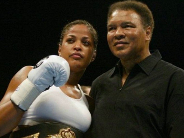 Laila Ali posing with Muhammad Ali