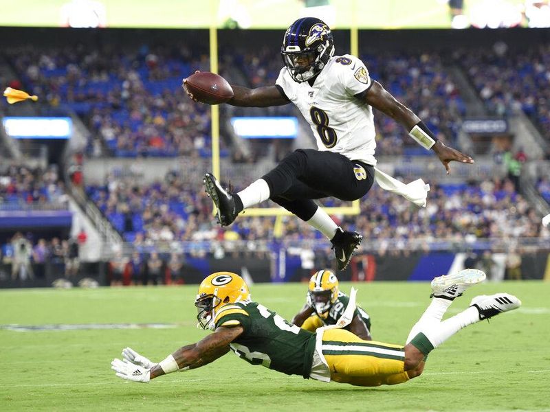 Lamar Jackson jumping over Packers defender