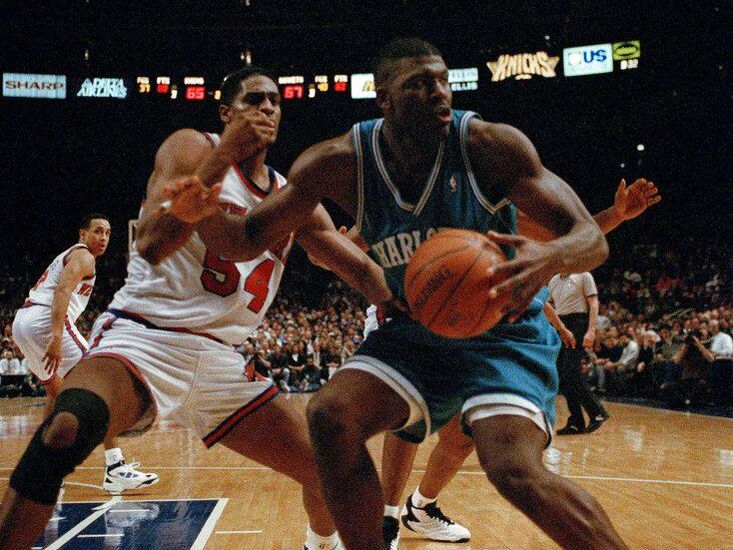 Larry Johnson drives against Charles Smith