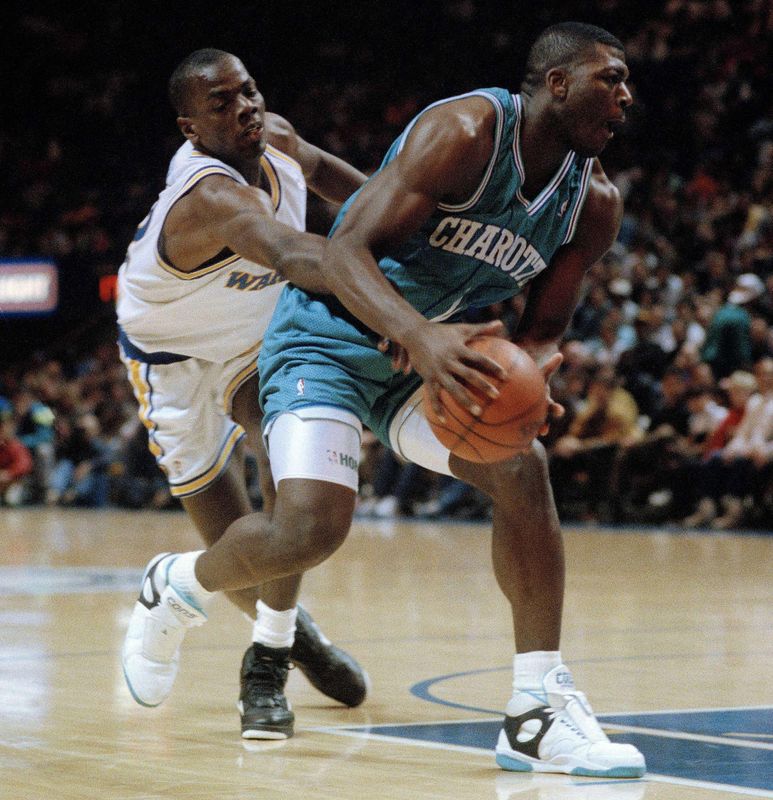 Larry Johnson puts a move on Tyrone Hill