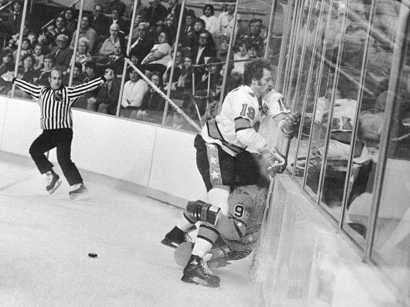Larry Robinson and Clark Gillies crash into the boards