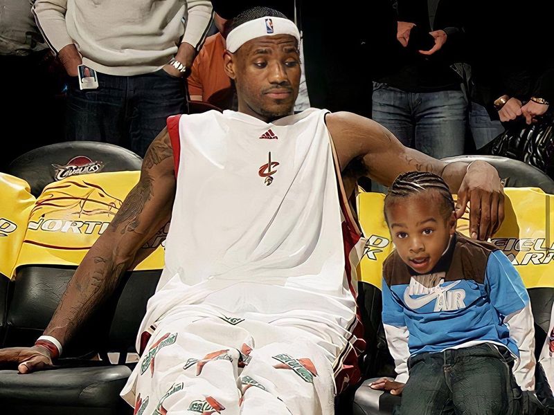 LeBron James with a young Bronny sitting on the Cleveland Cavaliers bench