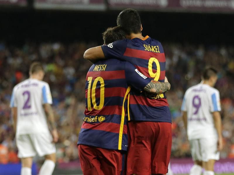 Lionel Messi embraces to his teammate Luis Suarez
