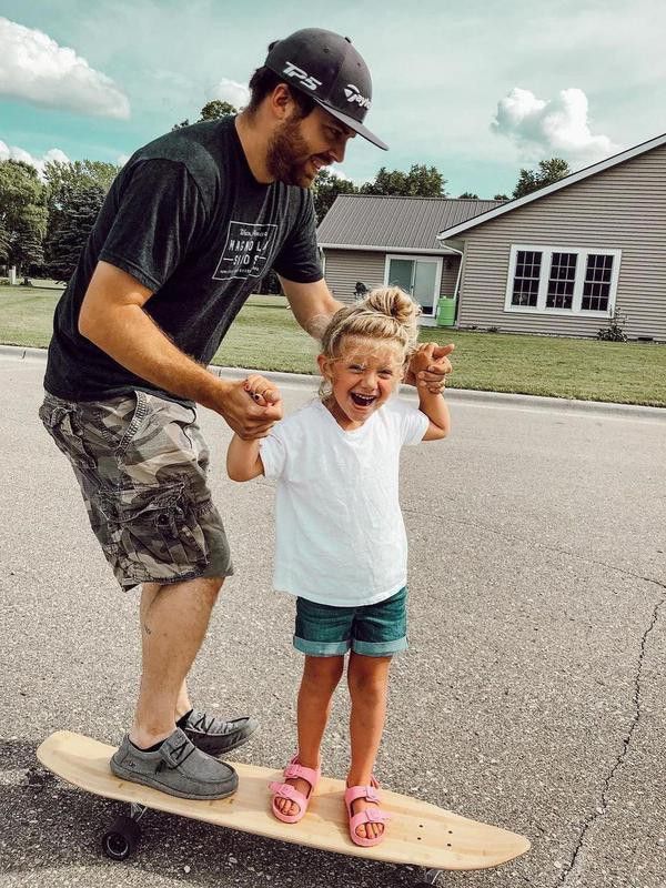 Little girl and her dad on a Magneto longboard