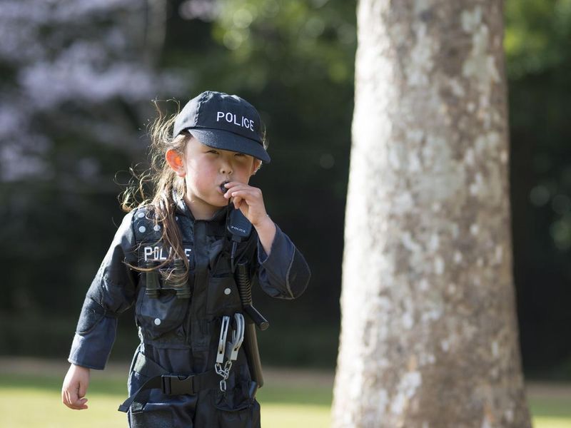 Little girl wearing police costume